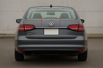 Volkswagen Jetta 2011–2018 Lišta nad ŠPZ (Carmos, nerezová oceľ) fotografia 1